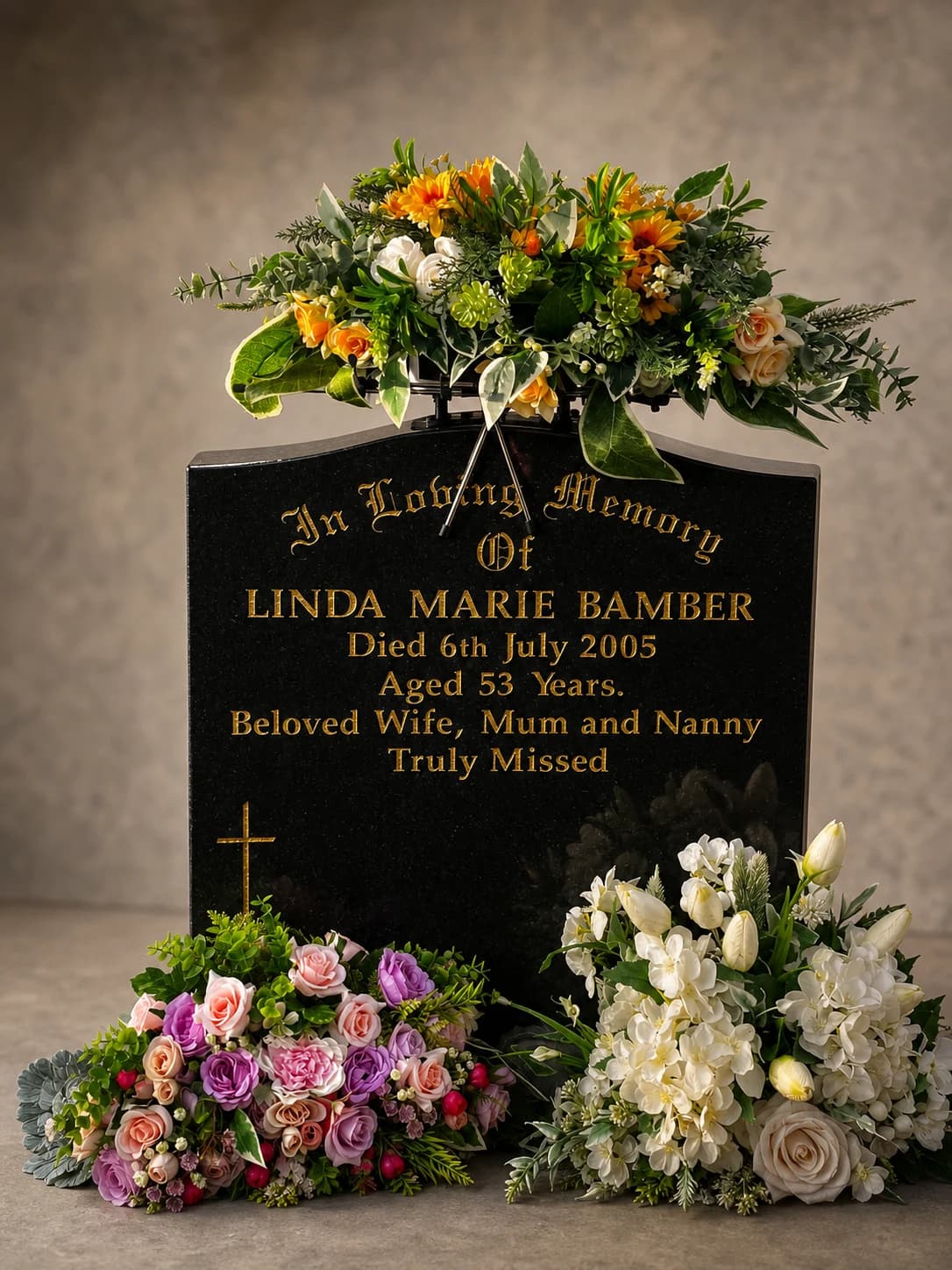 Studio display of the Memorial Topper holding a graveside floral tribute in place